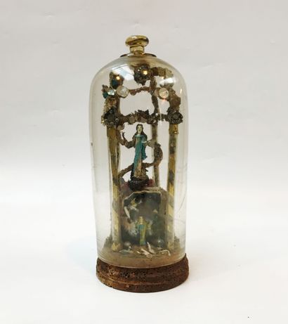 null Composition under a glass cloche containing a montage of Nevers filé figures...