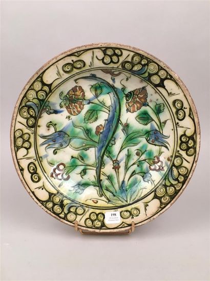 null Iznik Round siliceous ceramic dish with lead glaze and polychrome decoration...