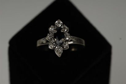 null Platinum "daisy" ring set with a shuttle-cut sapphire in a brilliant setting.
Weight:...