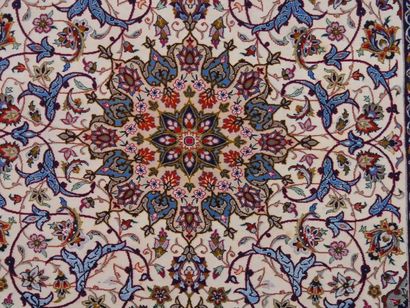 null Persian ISFAHAN wool and silk carpet with central rosette on an ivory background....