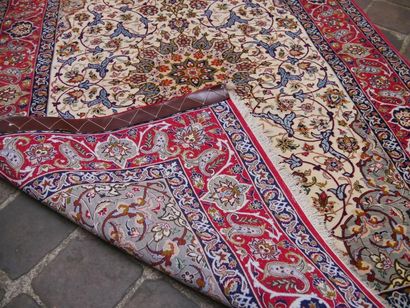 null Persian ISFAHAN wool and silk carpet with central rosette on an ivory background....
