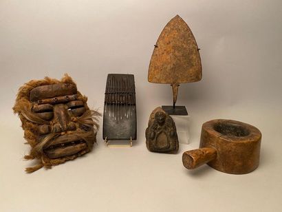 null Set of ethnic objects, including: 
- Ivory Coast, Healed Mask made of carved...