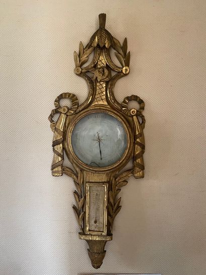 null BAROMETER-THERMOMETER in wood and gilded stucco, the round dial surmounted by...