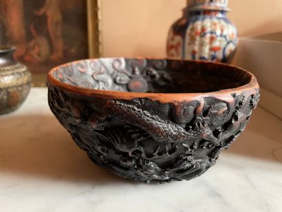 null CHINA, 20th century 

Carved and lacquered wooden bowl with rotating decoration...