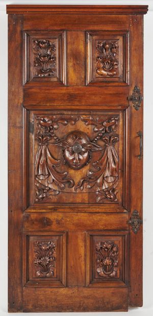 null Carved walnut door, with five compartments and decoration of foliage and head...