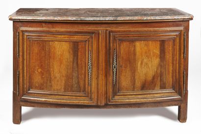 null A walnut sideboard with two doors, the wooden top resting on rounded jambs;...