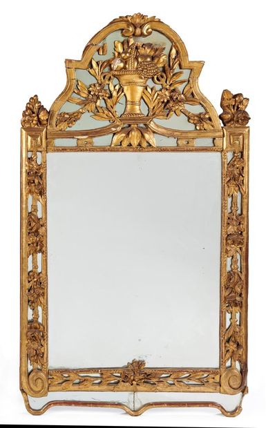 null A rectangular gilded wood mirror with openwork garlands of flowers and foliage,...