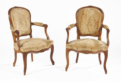 null Pair of natural beech armchairs with cabriolet backs, resting on arched legs;...