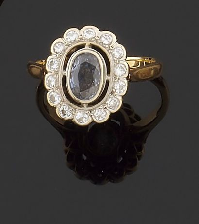 null Yellow gold ring 750 thousandths decorated in the center of an oval sapphire...