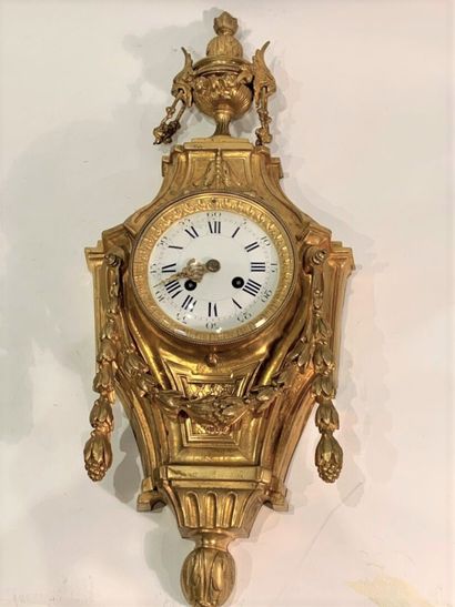 null A gilt bronze wall clock, the enamelled dial indicates the hours in Roman numerals...