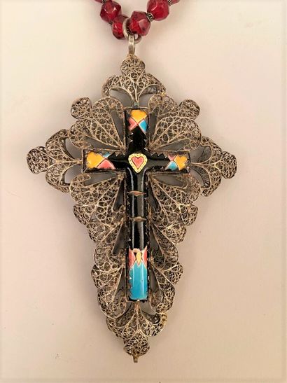 null Enamelled CROSS in a silvered metal filigree frame, held by a necklace with...