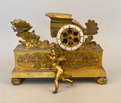 null An ormolu and chased bronze Love chariot hanging on a rectangular base decorated...