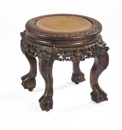 null Wooden TABOURET richly carved with dolphin heads and friezes in the belt, resting...