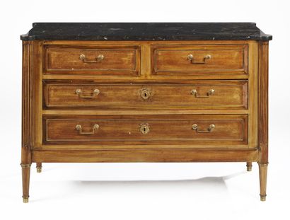 null A wood veneer chest of drawers with brass framing, opening with four drawers...