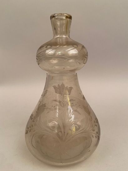 null GERMANY

A translucent and colorless blown glass bottle in the shape of a coloquint...