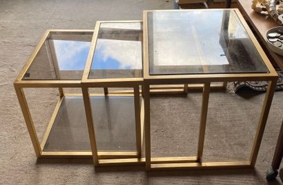 null THREE GIGOGNE TABLES, the structure in gilded metal, the tops in glass. 

Size...