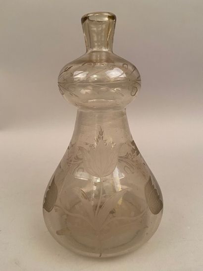 null GERMANY

A translucent and colorless blown glass bottle in the shape of a coloquint...