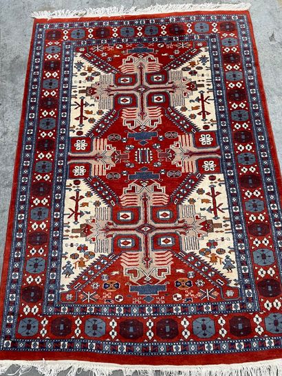 null Turkish carpet in wool with red background and geometrical decoration and friezes...