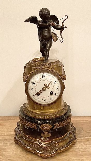 null A brown patina gilt bronze and green veined marble column clock decorated with...