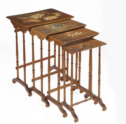 null FOUR painted wood nesting TABLES with polychrome decoration of flowers, the...