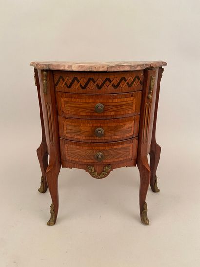 null A half-moon shaped master's chest of drawers inlaid with gilt bronzes and framing...
