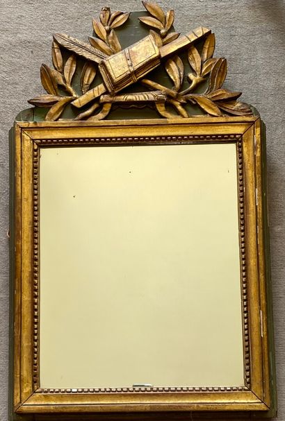 null Wood and gilded stucco pediment mirror decorated with a trophy and laurel leaves.

Louis...