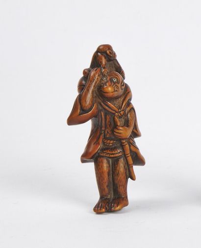 null JAPAN - 19th century

Wooden netsuke, monkey wearing clothes and holding a cane,...
