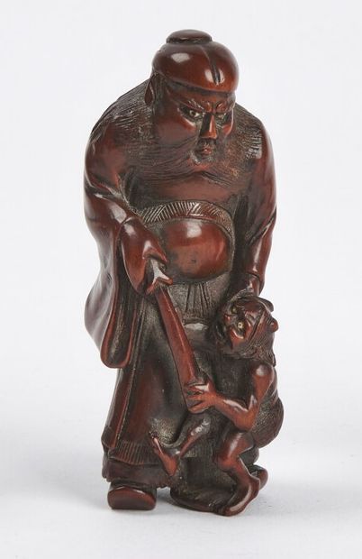 null JAPAN - 19th century

Wooden netsuke, Shoki standing with bone inlaid eyes catching...