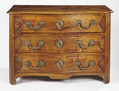 null A moulded fruitwood COMMODE, the curved front opening to three drawers, the...