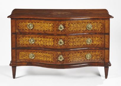 null A chest of drawers in olive wood marquetry on a walnut base, the curved front...
