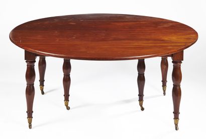 null Mahogany dining table of circular form, resting on six double baluster legs;...