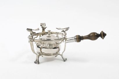 null A tripod silver openwork candleholder, decorated with shells, the feet with...