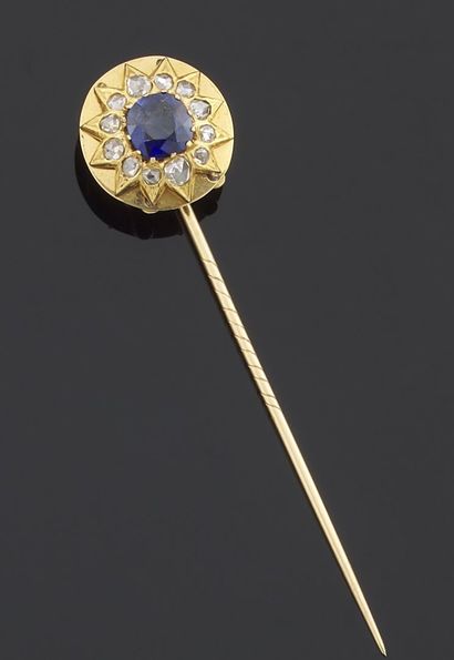 null Tie pin in yellow gold 750 thousandths, the end decorated with a blue synthetic...