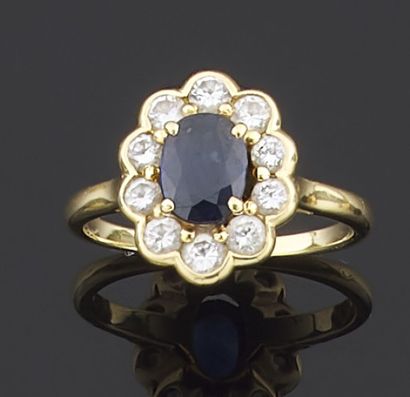 null Yellow gold ring 750 thousandths decorated in the center of an oval sapphire...