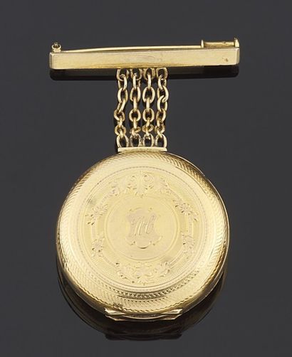 null BROCHE en or jaune 750 millièmes retenant en pendentif une montre de dame également...
