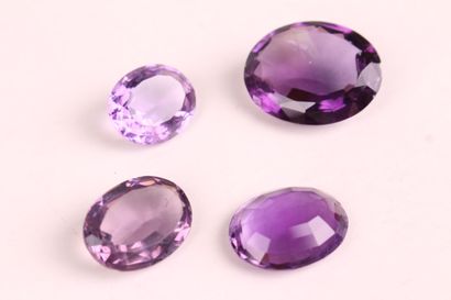 A SET of three oval amethysts on paper weighing...
