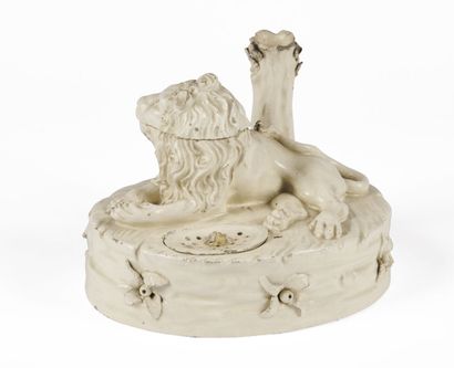 null EASTERN FRANCE

A white glazed earthenware desk with a lion lying on an oval...