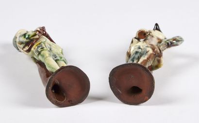 null STAFFORDSHIRE

Two glazed earthenware statuettes representing a flute player...