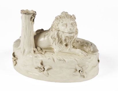null EASTERN FRANCE

A white glazed earthenware desk with a lion lying on an oval...
