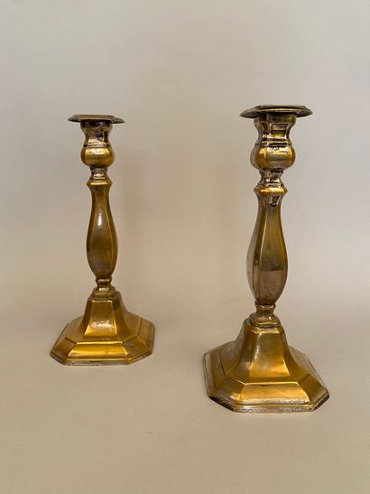 null TWO silver-plated copper candlesticks, the baluster shaft resting on a base...