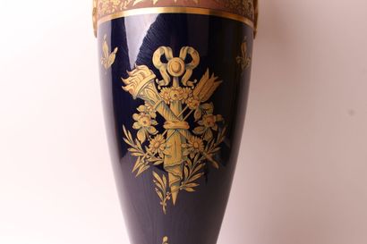 null A large porcelain baluster vase with two handles, decorated with a trophy and...