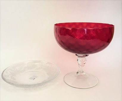 null A red glass CUP on a translucent glass baluster foot. 

Height 21,5 cm; Diameter...