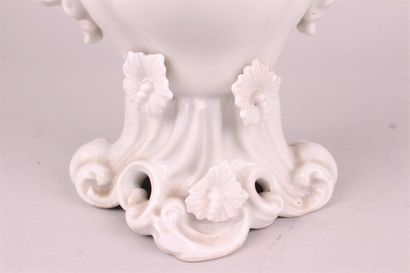 null PARIS 

A white enamelled porcelain bridal vase decorated with flowers in relief,...