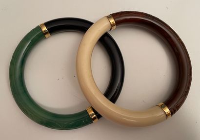 null GIVENCHY Paris 

Two resin bracelets in imitation of jade, amber and ivory and...