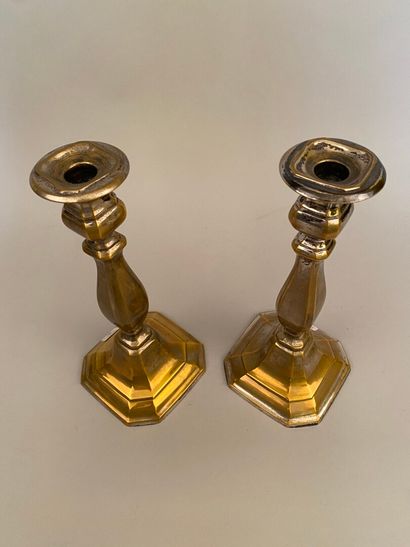 null TWO silver-plated copper candlesticks, the baluster shaft resting on a base...