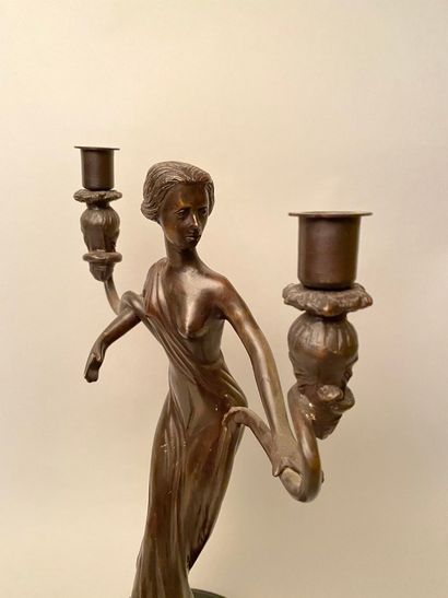 null Early 20th century work 

Bronze candlestick with brown patina representing...