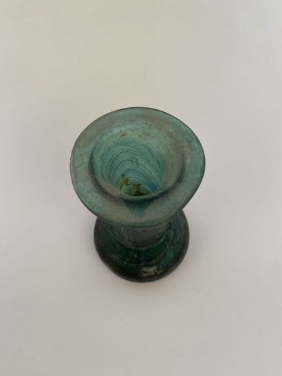 null A small baluster-shaped vase with a green background. 

Height 10,5 cm