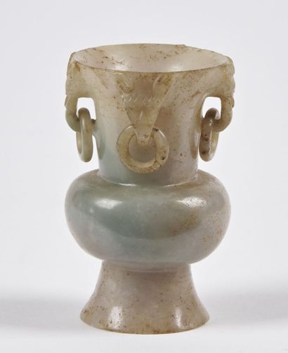 null CHINE - XIXe siècle

Vase miniature de style archaïque en jadéite, le col sculpté...