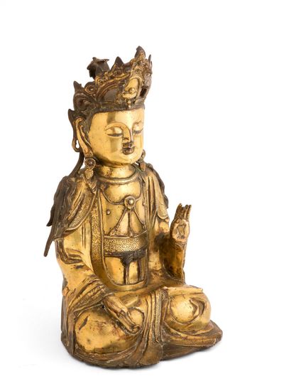 null CHINA - MING period (1368 - 1644)

Statuette of Guanyin in gilded bronze, seated...
