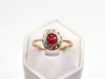 null Yellow gold ring 750 thousandth, the center decorated with a red imitation stone...